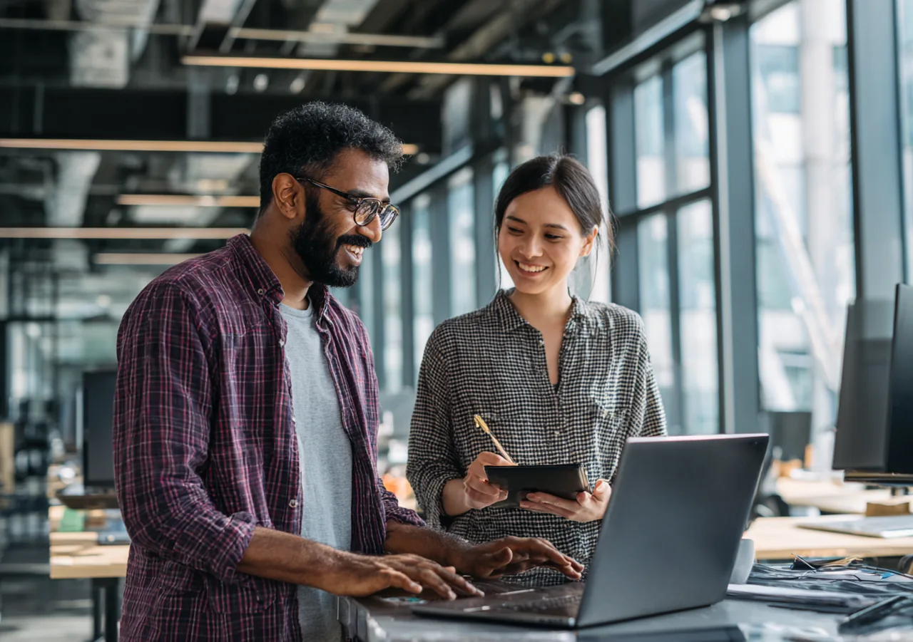 Illustration of two Indian software professionals collaborating at a workstation